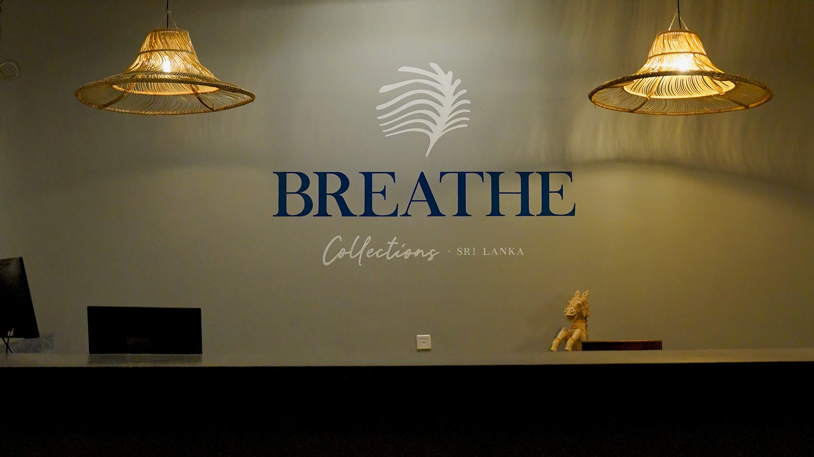 Breathe Collections brand wall with rattan lanterns